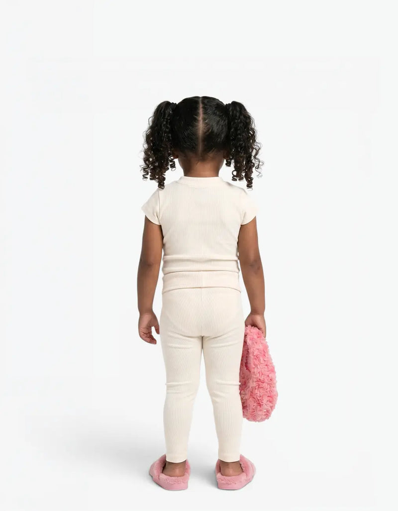 Cream ribbed two-piece set on a girl, back view, featuring Laboosh™ branding on the chest, photographed on a clean white backdrop. — alt view