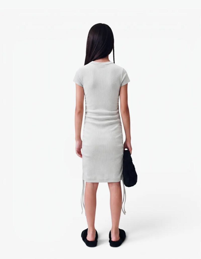 Back view of a grey ribbed ruched dress with short sleeves for girls, worn by a model on a white background — alt view