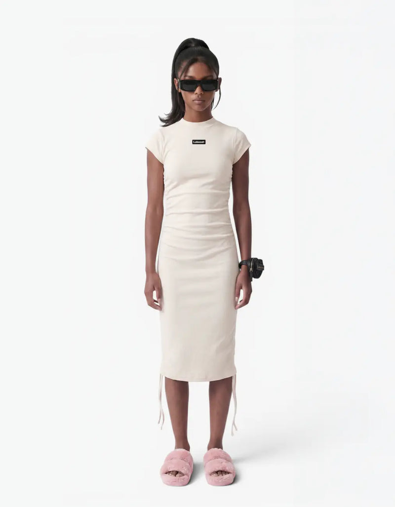 Cream ribbed ruched dress for girls, front view, with the Laboosh™ logo on the chest, on a white background