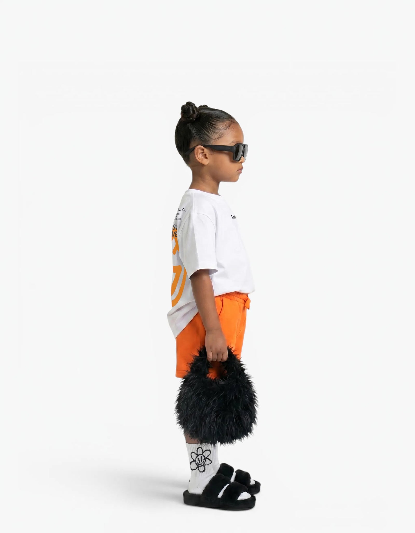 Orange Shorts for girls by Laboosh, side view on a white background