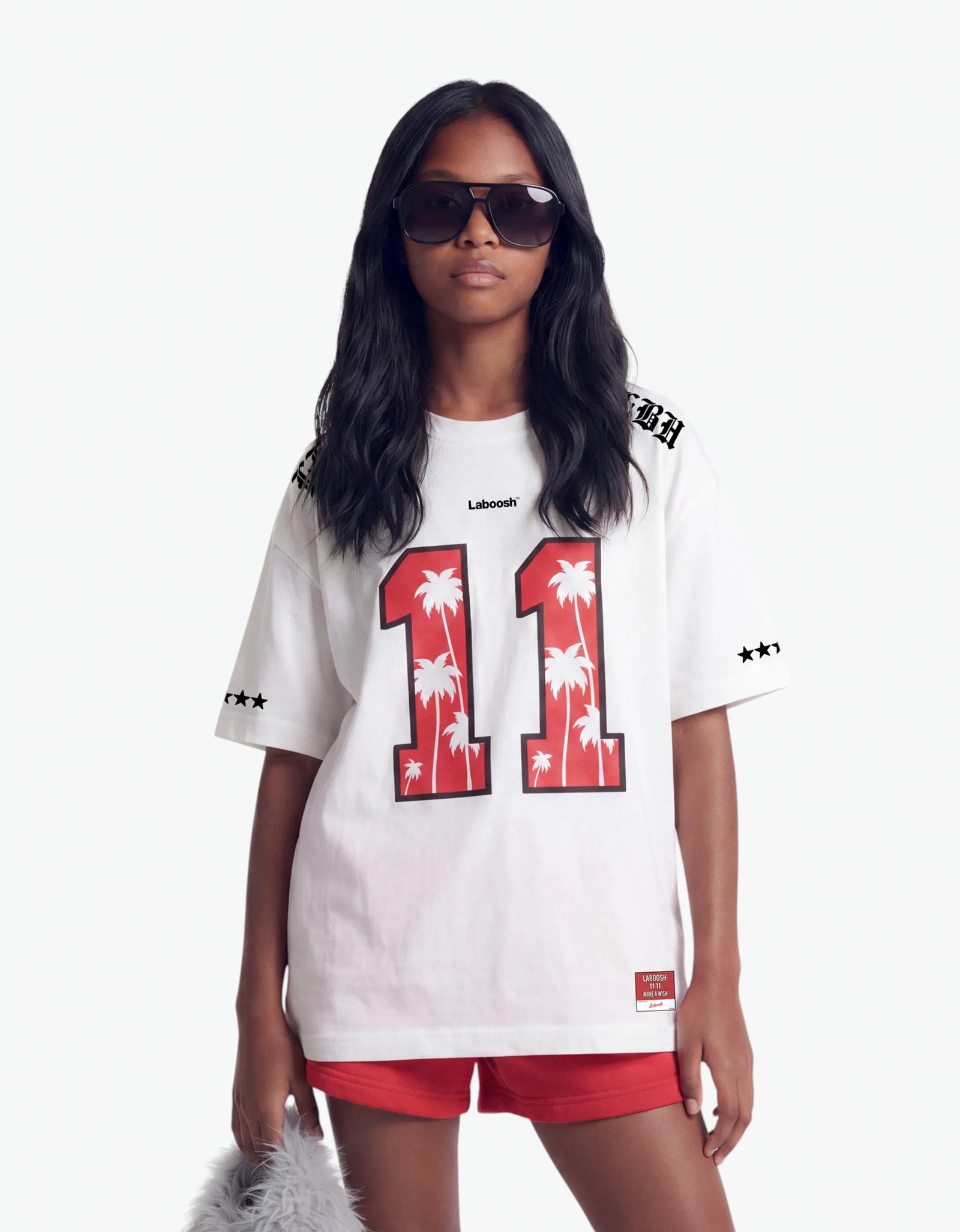Girl in white t-shirt from 11:11 Make a Wish, half-body view, with a signature Laboosh™ print, styled with matching 11:11 Make a Wish pieces.