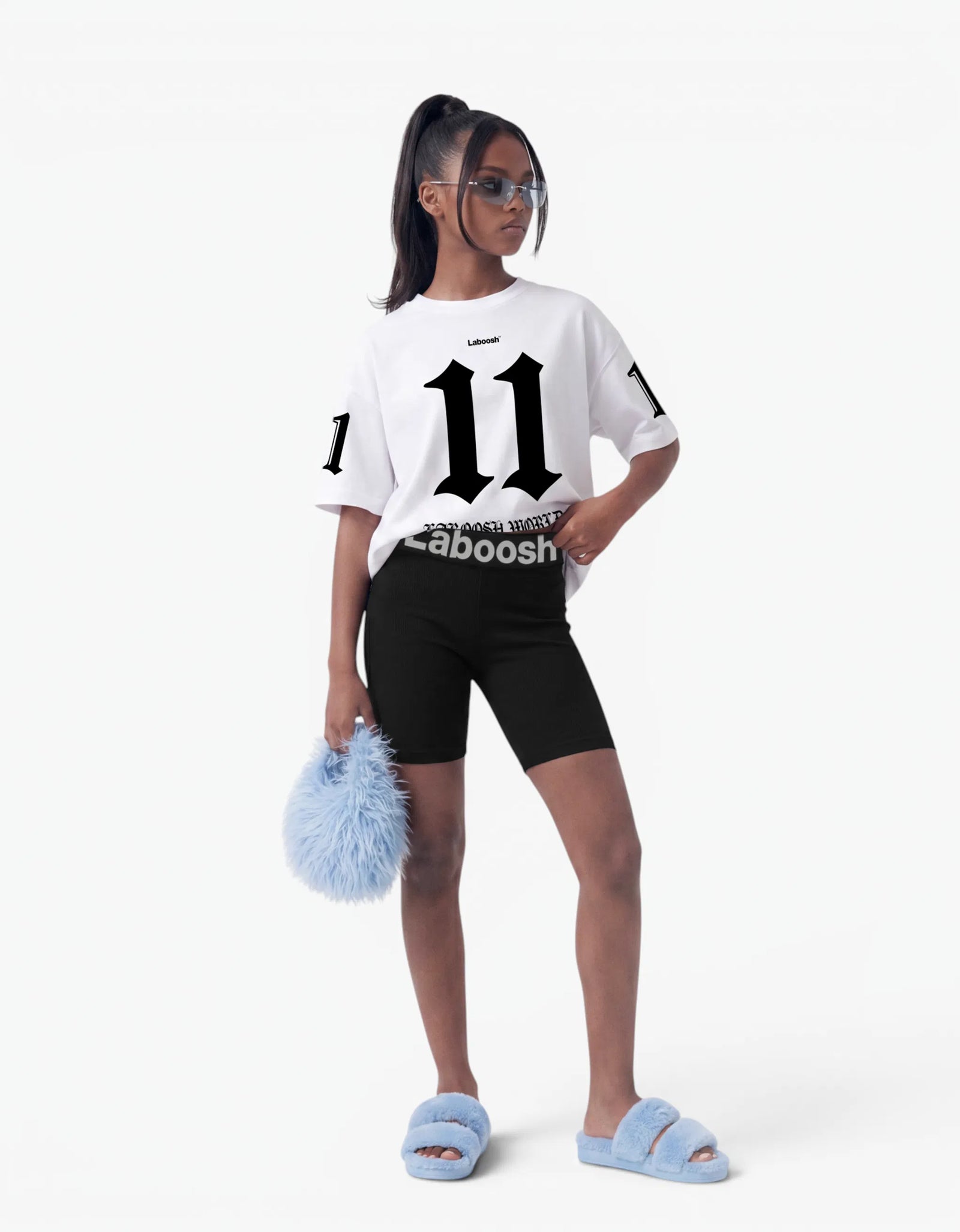 Girl in white t-shirt from 11:11 Make a Wish, front view, with a signature Laboosh™ print, against a bright white background.
