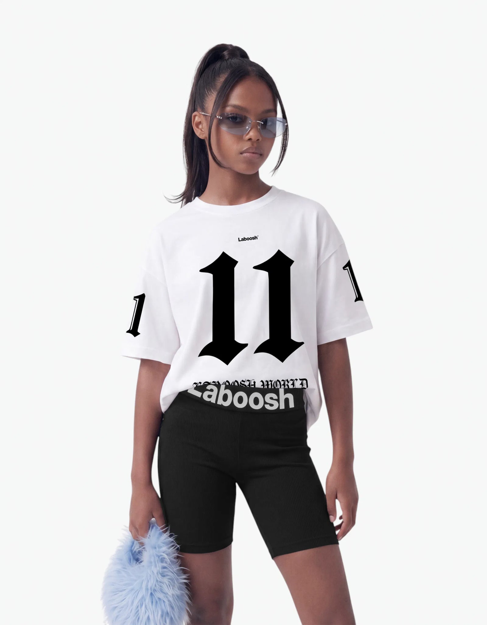 White t-shirt from the 11:11 Make a Wish, half-body view, with a signature Laboosh™ print, styled with matching 11:11 Make a Wish pieces.