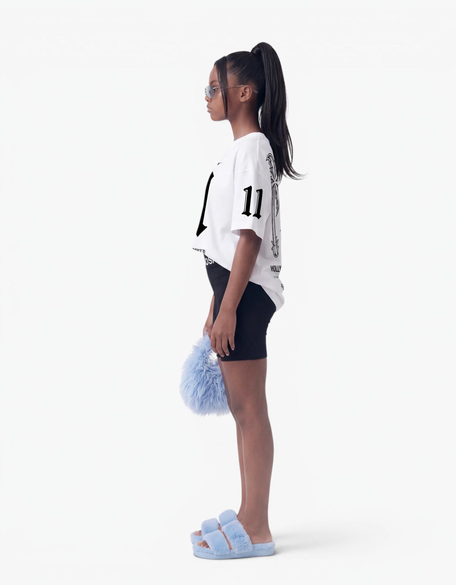 Girl in white t-shirt from 11:11 Make a Wish, side view, with a signature Laboosh™ print, photographed on a plain white background.