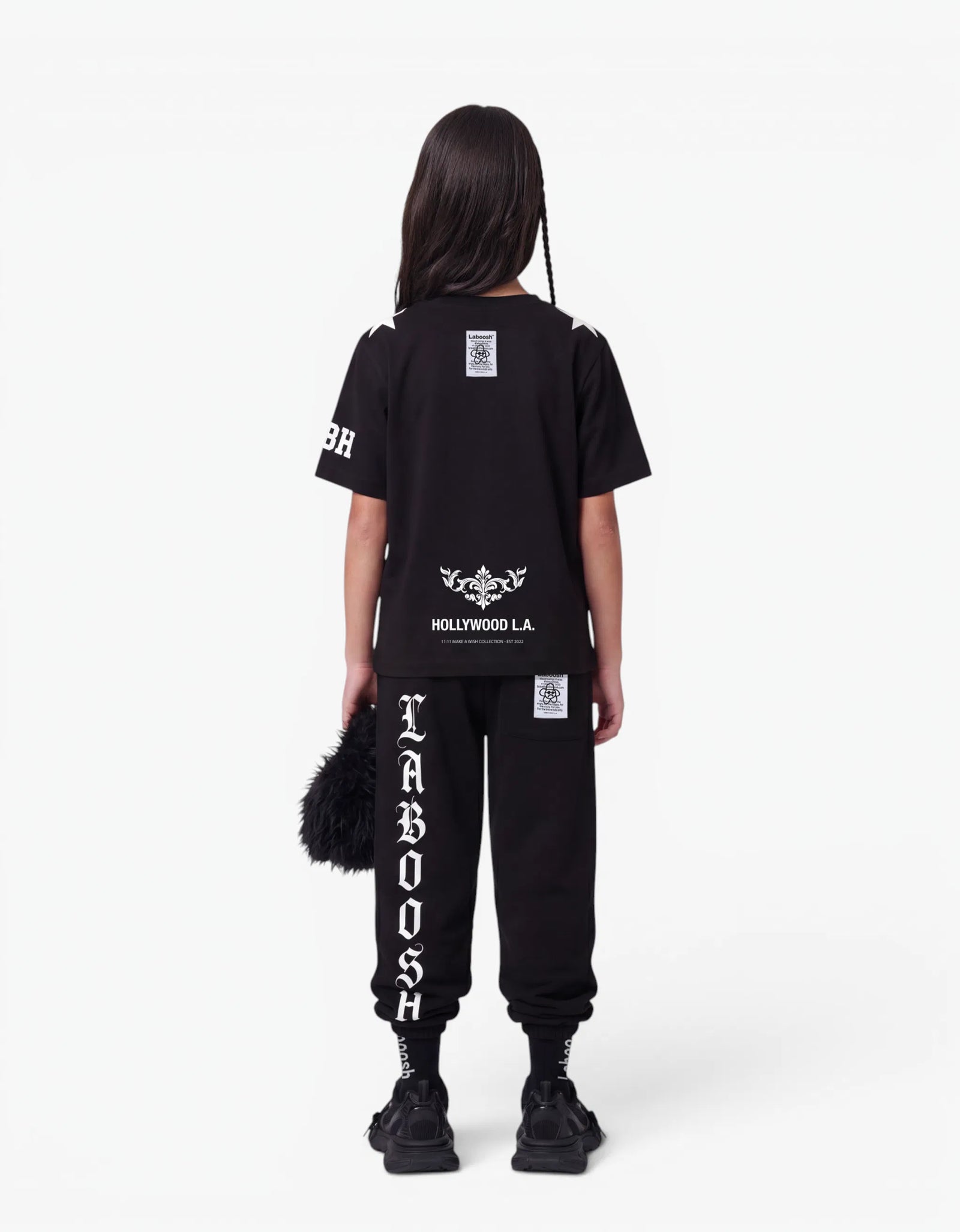 Black t-shirt from the 11:11 Make a Wish, back view, with a signature Laboosh™ print, against a bright white background.