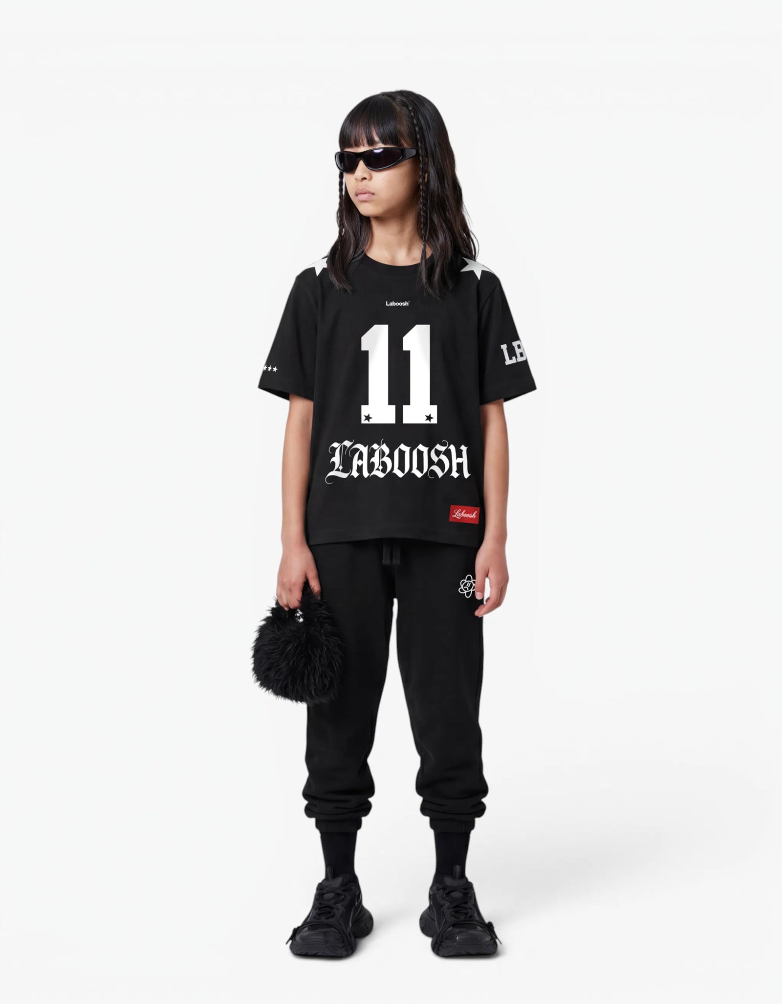Black t-shirt from the 11:11 Make a Wish, front view, with a signature Laboosh™ print, on a white studio backdrop.
