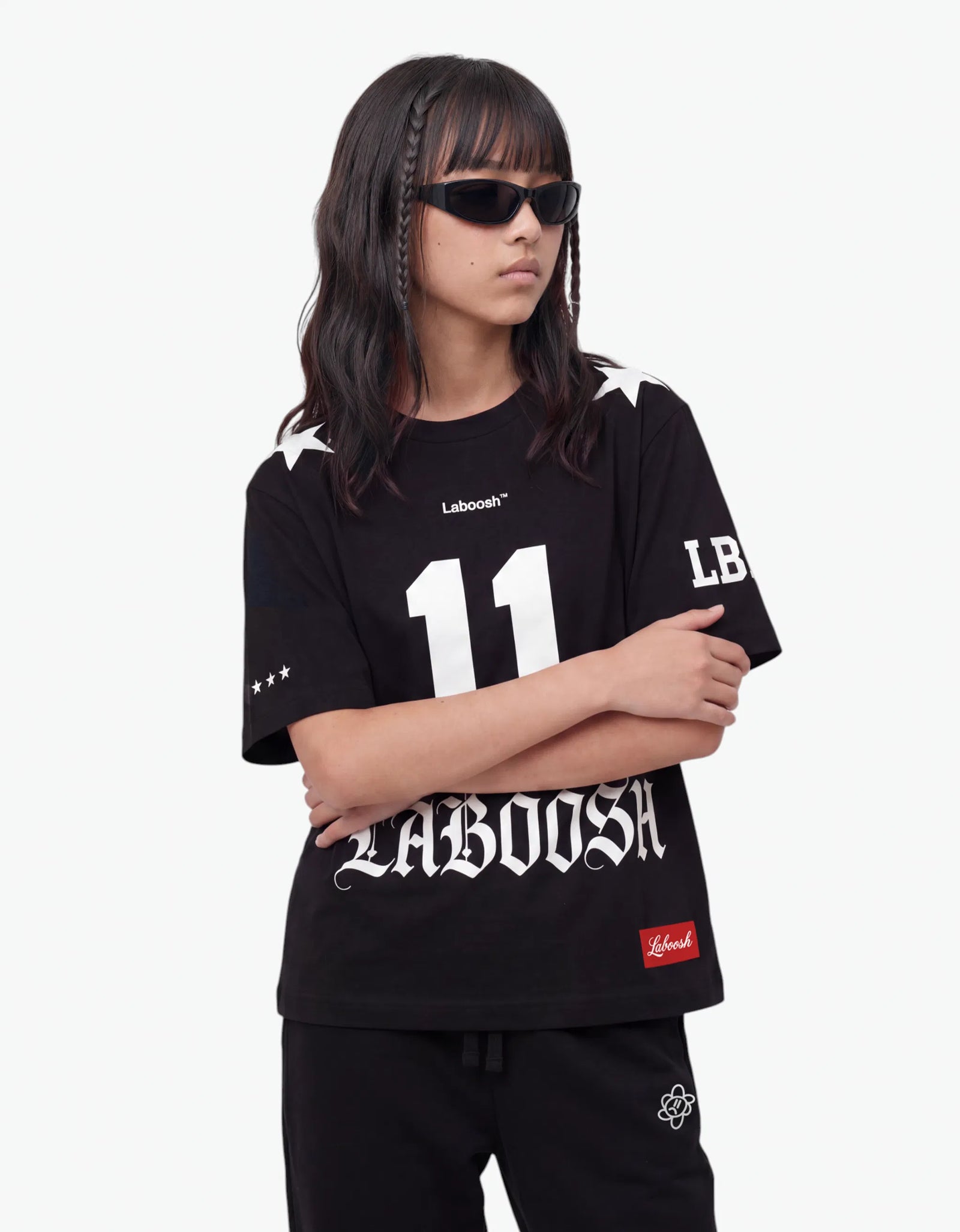Black t-shirt from the 11:11 Make a Wish, half-body view, with a signature Laboosh™ print, shown with coordinating 11:11 Make a Wish staples.