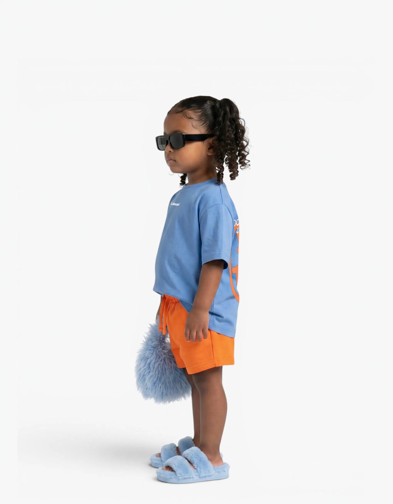 Orange Shorts for girls by Laboosh, side view on a white background