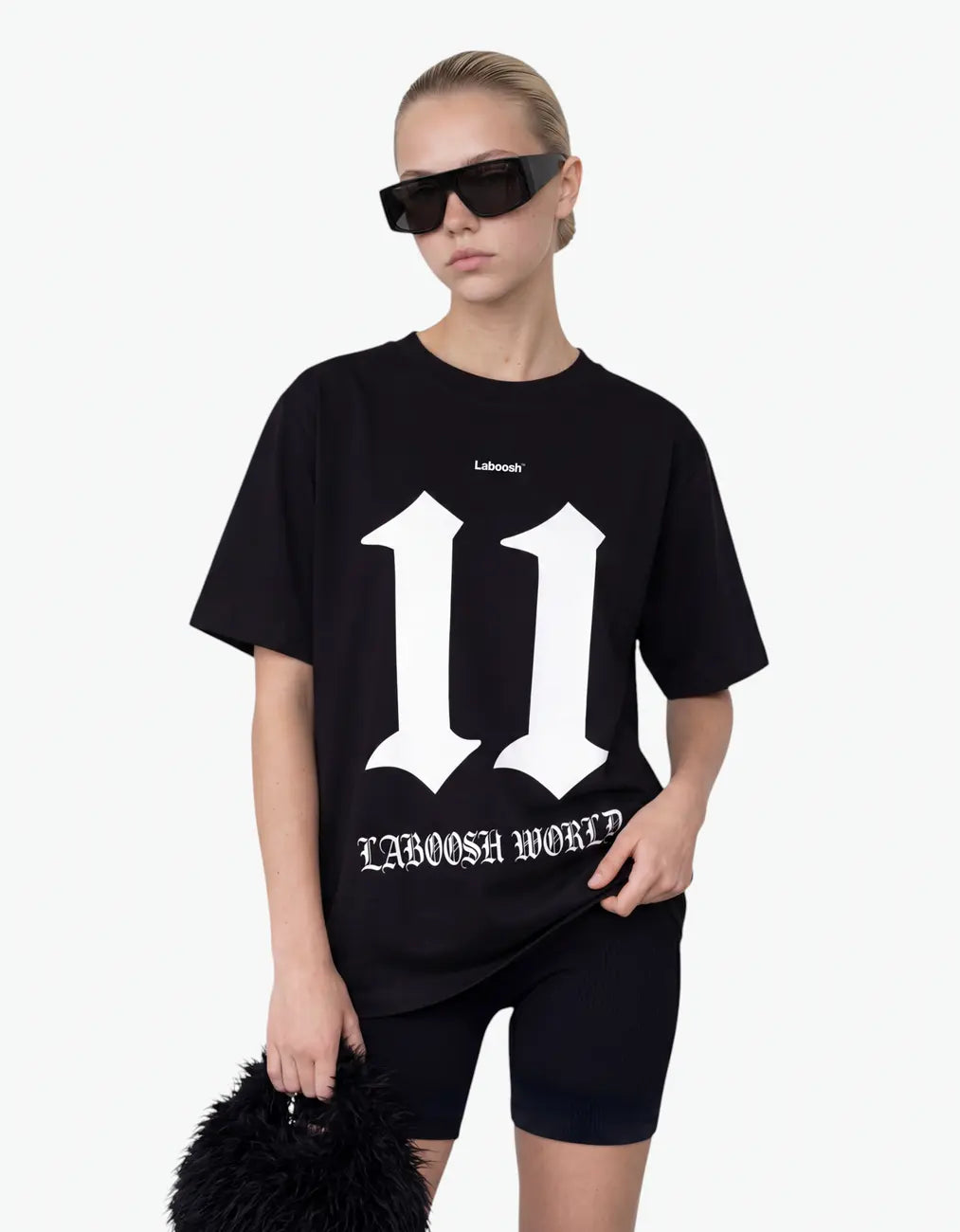 Black t-shirt for girls, half-body view, with a signature Laboosh™ print, styled with matching 11:11 Make a Wish pieces.