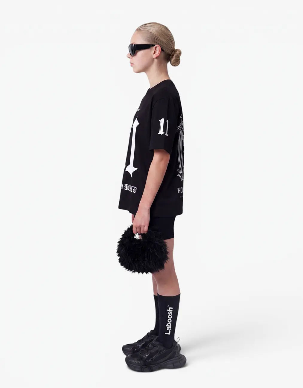 Girl in black t-shirt from 11:11 Make a Wish, side view, with a signature Laboosh™ print, shown with coordinating 11:11 Make a Wish staples.