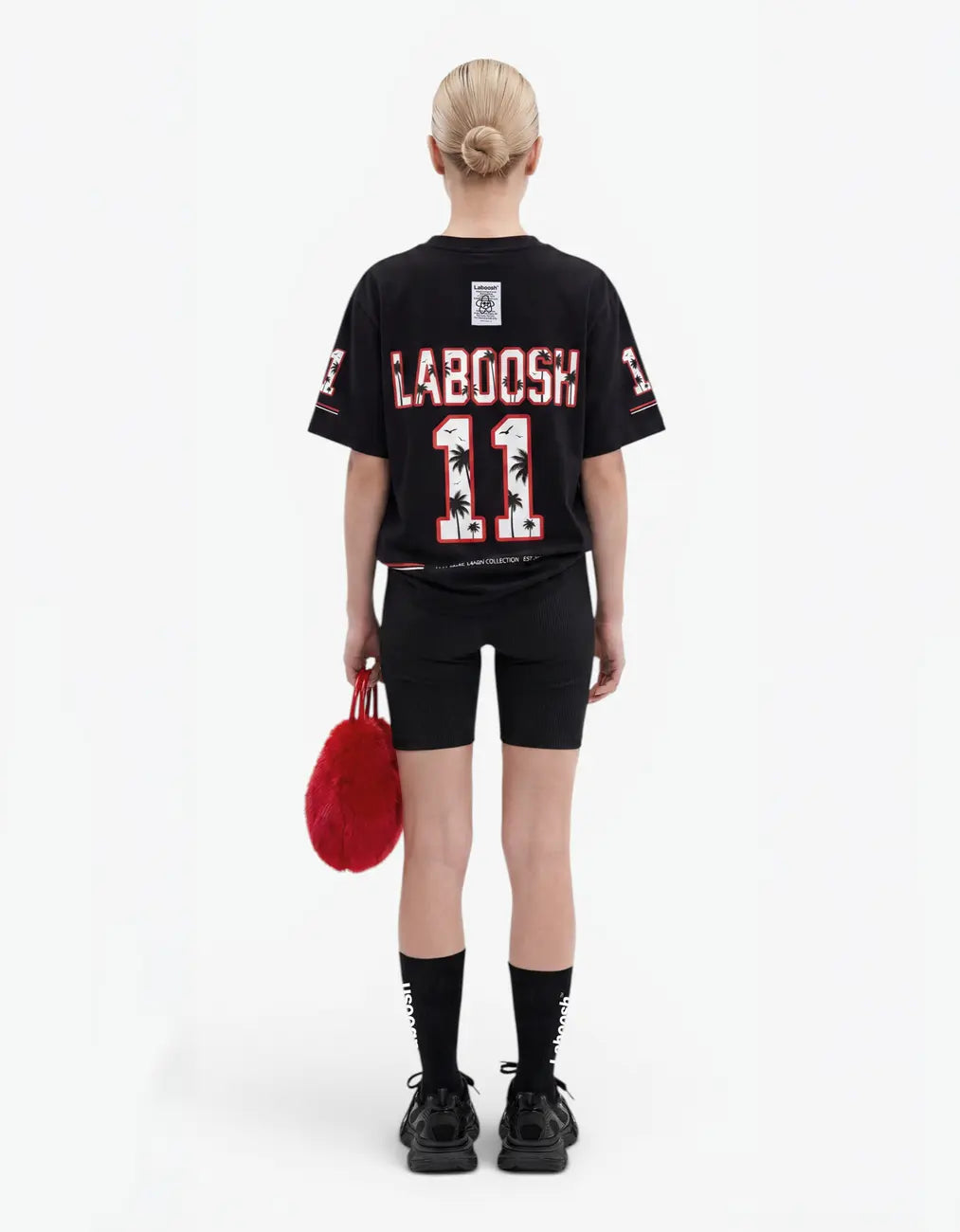 Black t-shirt for girls, back view, with a signature Laboosh™ print, on a white studio backdrop.