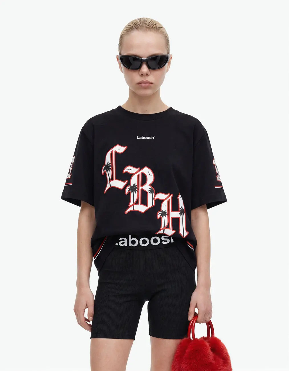 Girl in black t-shirt from 11:11 Make a Wish, half-body view, with a signature Laboosh™ print, styled with matching 11:11 Make a Wish pieces.