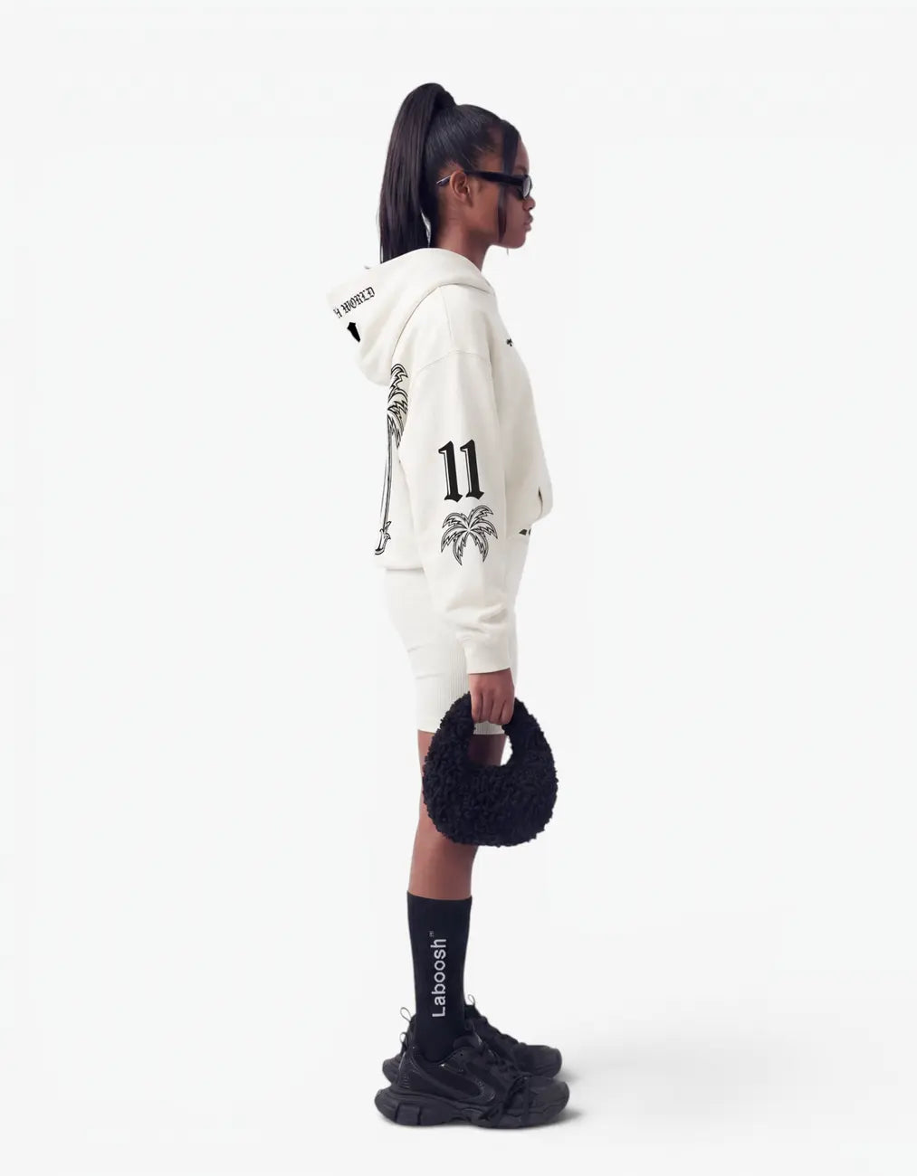 Oversized hoodie on a girl, side view, featuring Laboosh™ branding on the chest, shown with coordinating 11:11 Make a Wish staples.