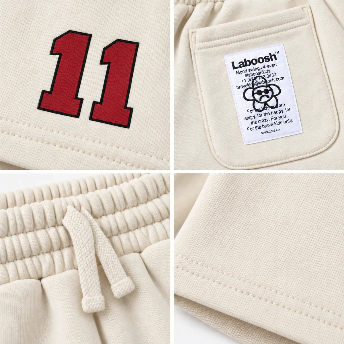 Cream 11:11 boys shorts craftsmanship details: red number print, Laboosh back-pocket label, drawstring waistband and hem stitching.