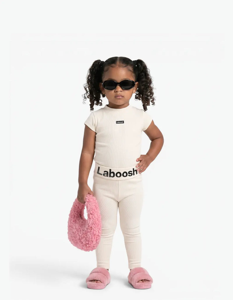 Girl wearing Cream ribbed two-piece set, front view, with Laboosh™ branding on the chest, styled with matching MoodSwings pieces.