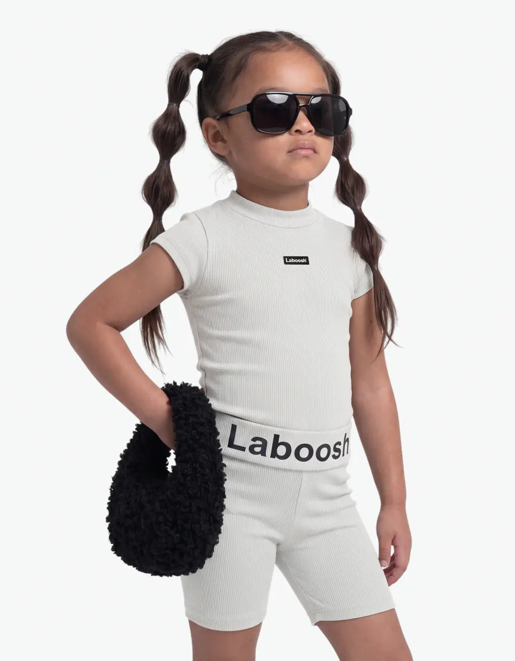 Girl wearing Grey ribbed two-piece set, half-body close-up, with Laboosh™ branding on the chest, shown with coordinating MoodSwings staples.