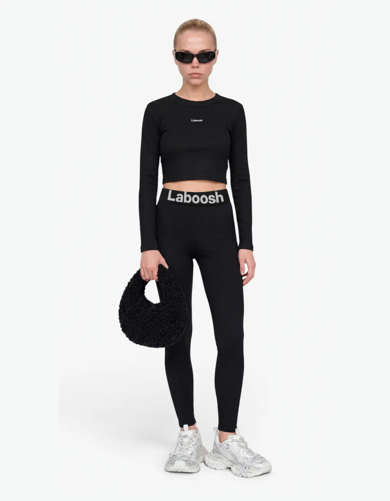 Black ribbed long leggings for girls with Laboosh logo waistband, front view, paired with matching crop top on a white background