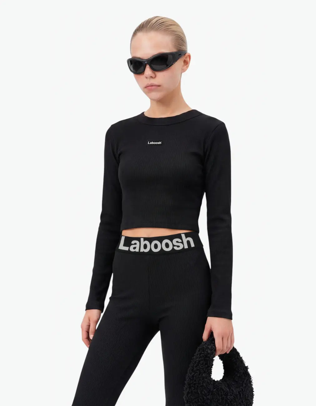 Black ribbed long leggings for girls close-up showing the Laboosh logo waistband and soft stretch cotton fabric on a white background