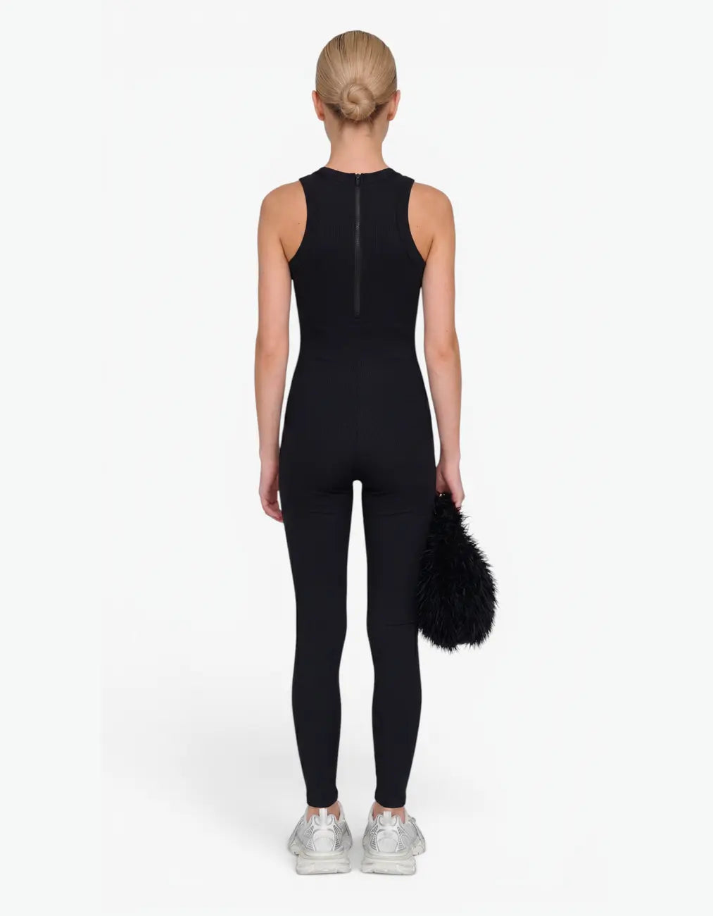 Black ribbed romper with long pants for girls, back view on white background
