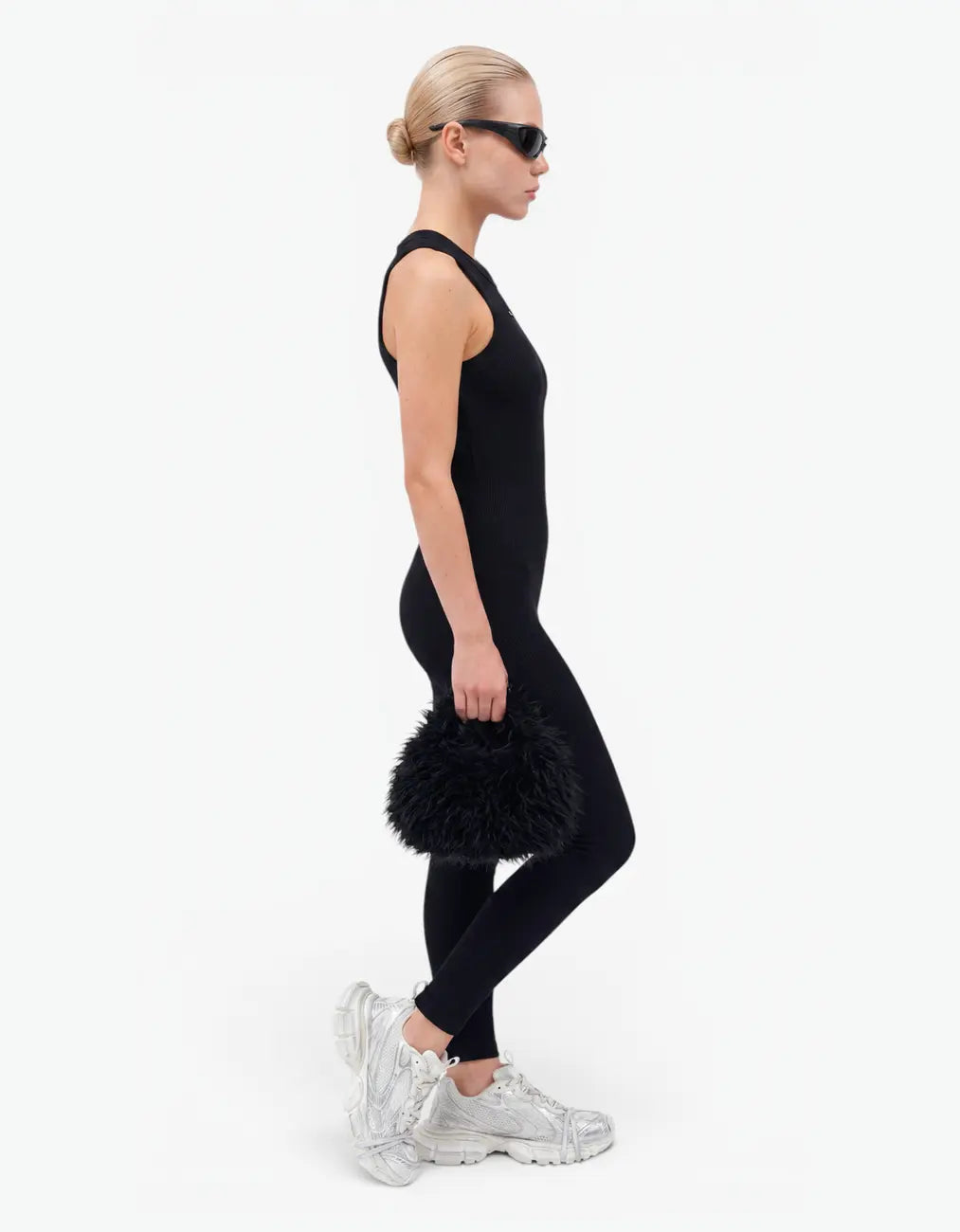 Black ribbed romper with long pants for girls, side view on white background