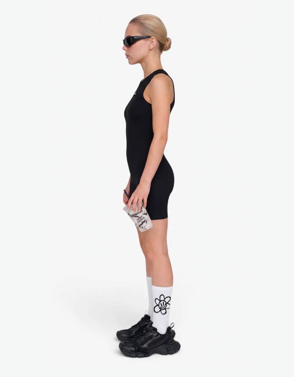 Black ribbed short romper for girls, side view on white background