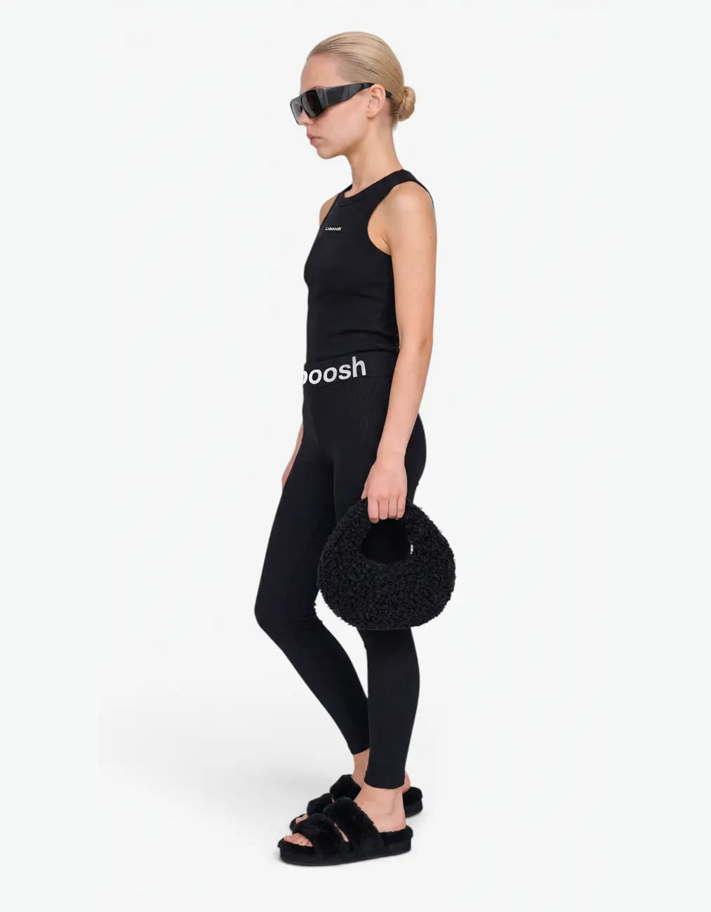 Black ribbed tank top for girls by Laboosh™, side view, sleeveless ribbed-knit tank with matching black leggings and Laboosh™ logo waistband on a white background