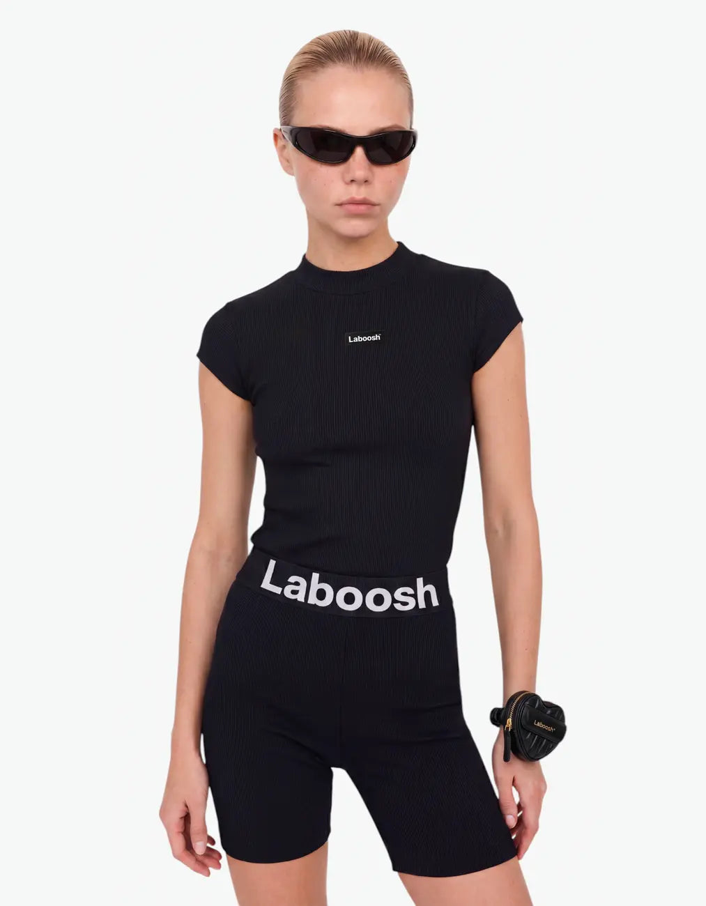 Black ribbed biker leggings for girls with Laboosh logo waistband, half-body close-up on white background