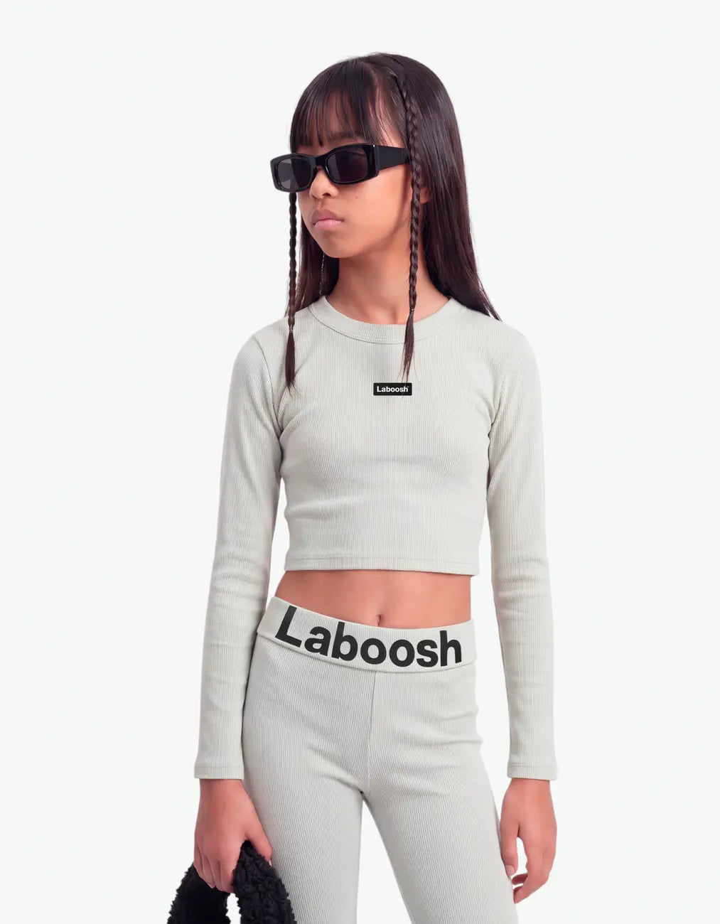 Grey ribbed long leggings for girls by Laboosh™, half-body close-up showing the ribbed-knit texture and bold Laboosh™ logo waistband, paired with a matching grey ribbed crop top on a white background
