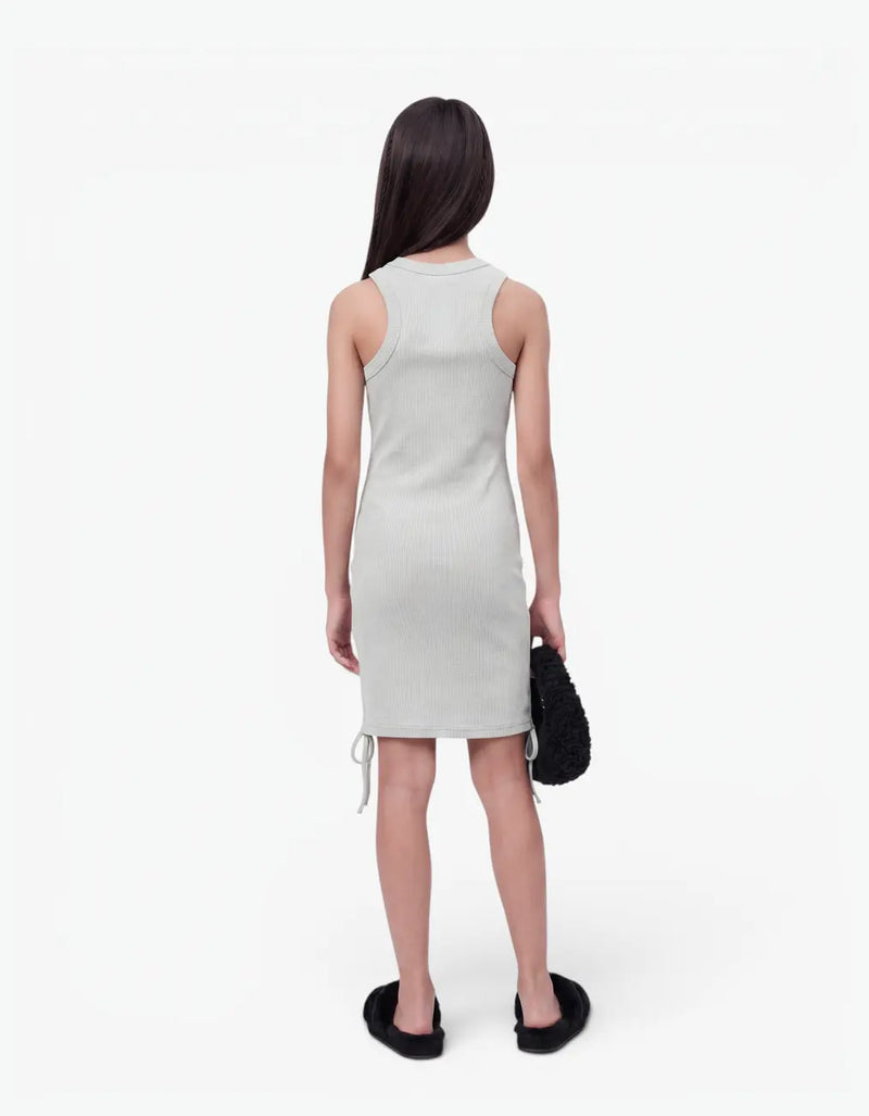 Back view of a girl wearing the grey ribbed ruched dress, showing the fitted sleeveless ribbed back and ruched hem ties, on a white background — alt view