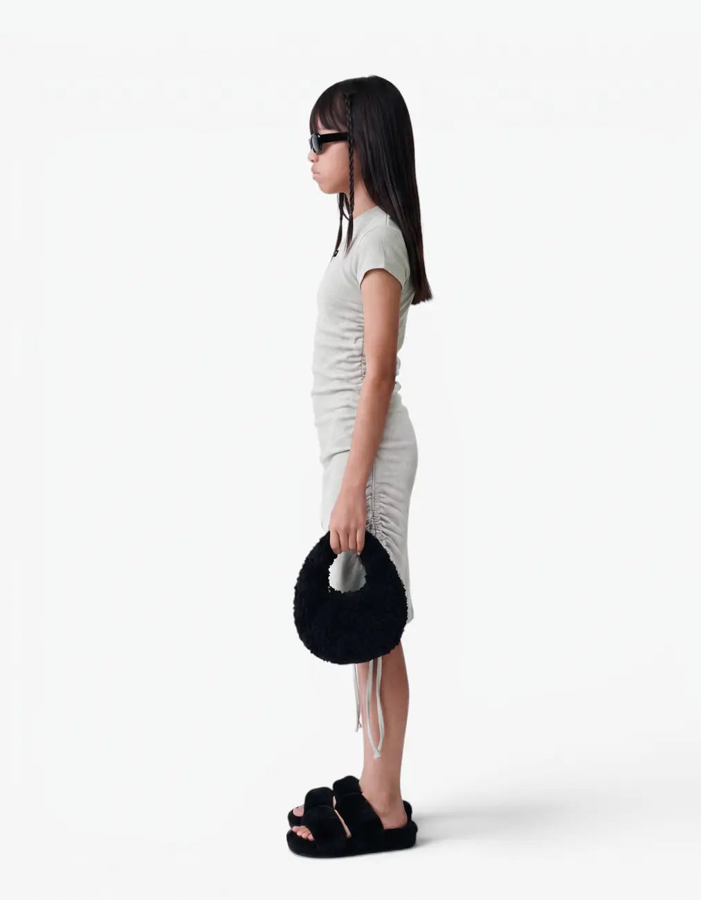 Side view of a grey ribbed ruched dress with short sleeves for girls, showing the ruched fit, on a white background