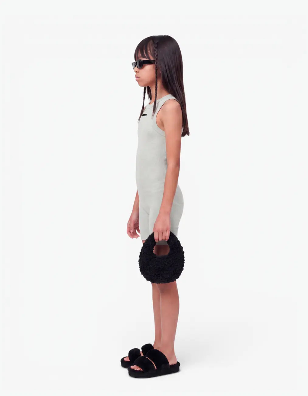 Grey ribbed short romper for girls, side view on white background