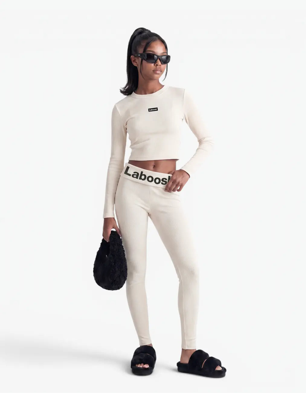Cream ribbed crop top for girls by Laboosh™, front view, long-sleeve cropped ribbed-knit top with Laboosh™ logo on the chest, styled with matching cream ribbed leggings on a white background