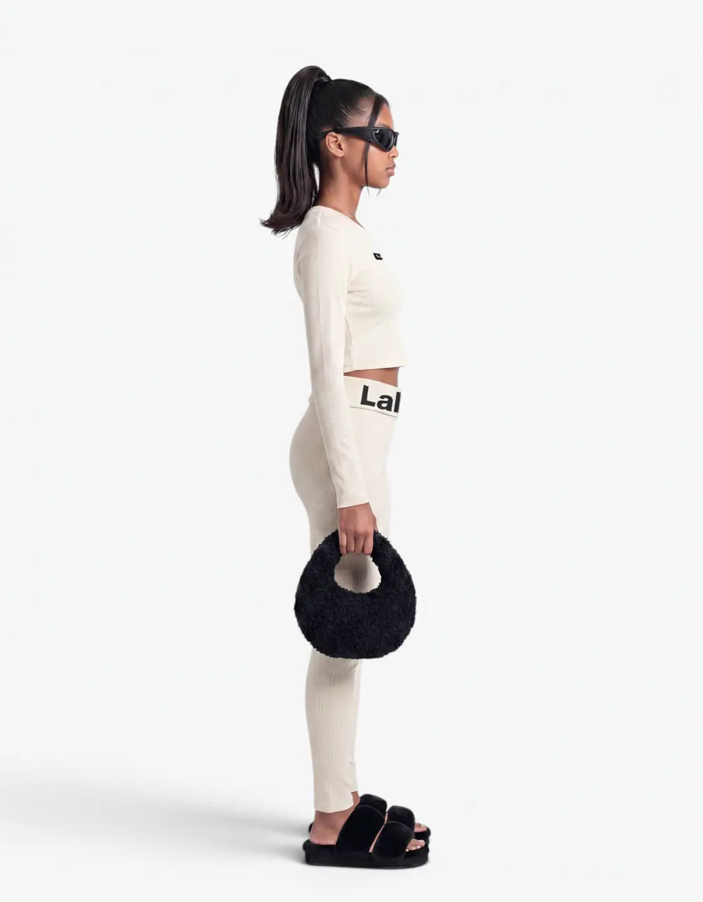 Cream ribbed crop top for girls by Laboosh™, side view, long-sleeve cropped ribbed-knit top with matching cream leggings and Laboosh™ logo waistband on a white background