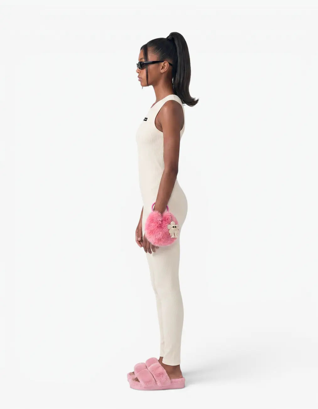 Cream ribbed romper with long pants for girls, side view on white background