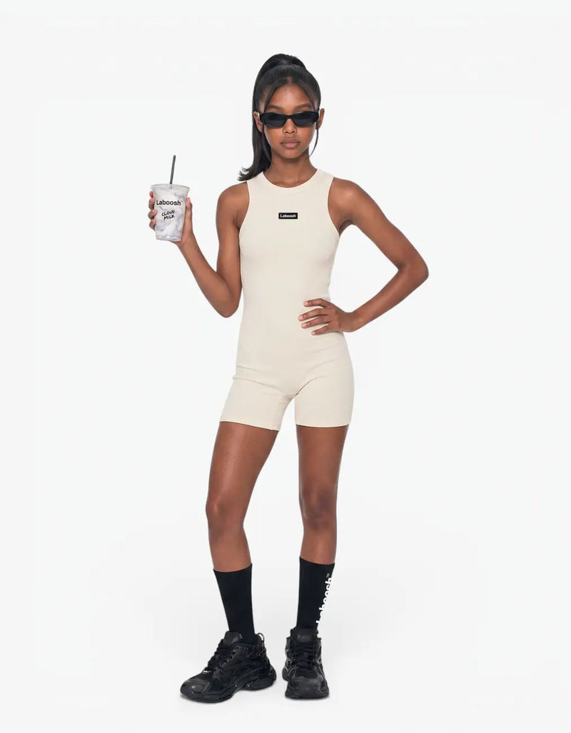 Cream ribbed short romper for girls with Laboosh logo, front view on white background