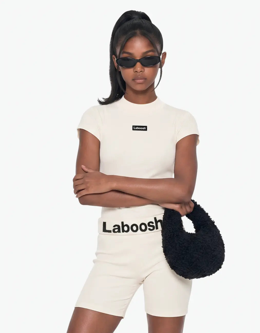Cream ribbed short sleeve top for girls, half-body view, with the Laboosh™ logo on the chest, against a bright white background.