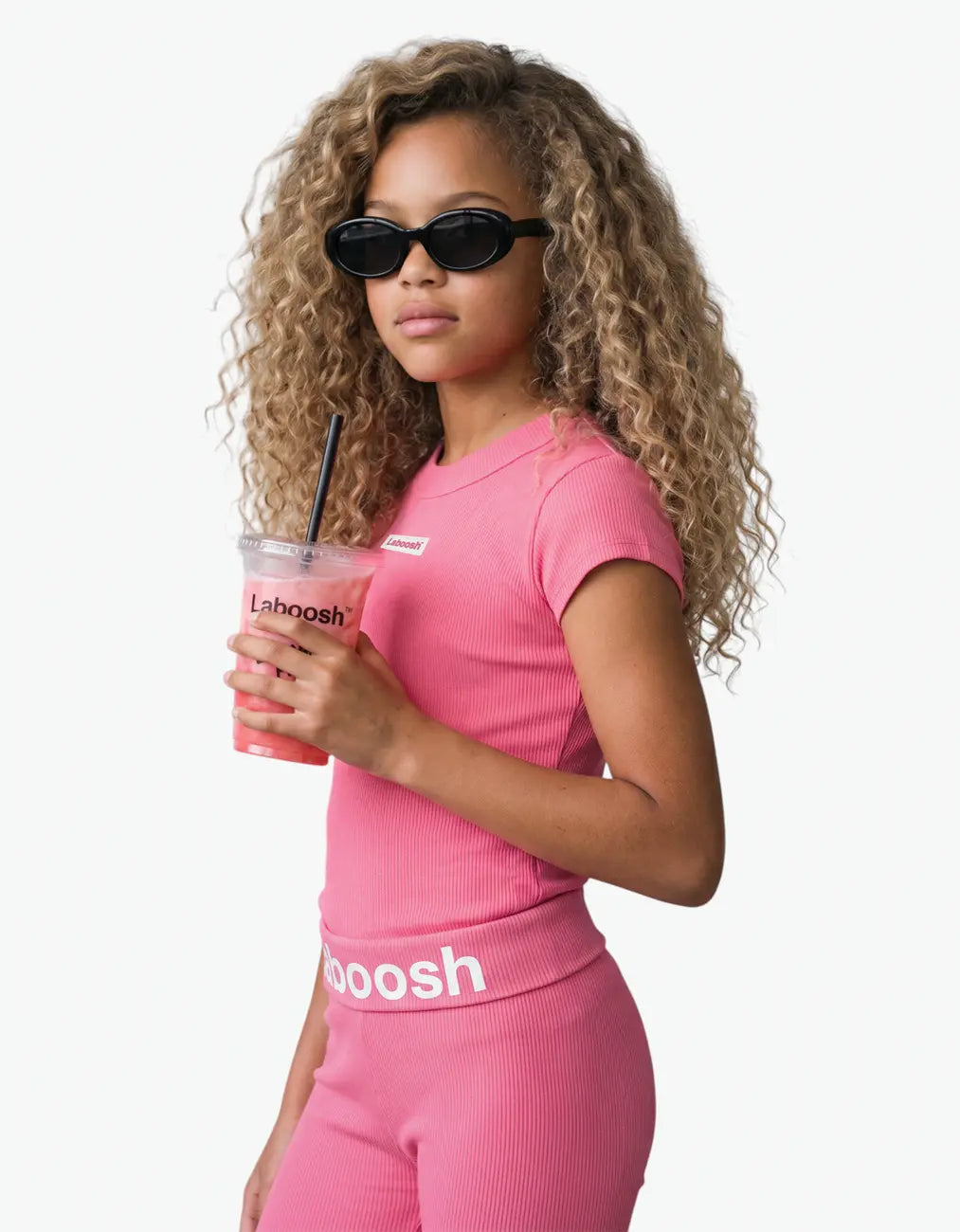 Pink ribbed short sleeve top for girls, half-body view, with the Laboosh™ logo on the chest, photographed on a plain white background.