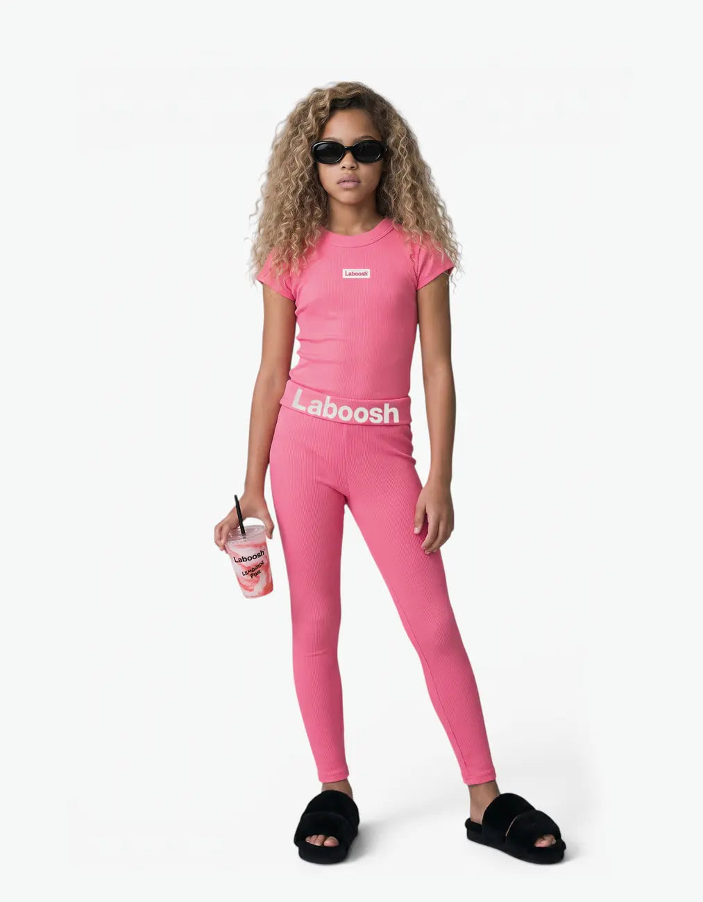 Girl in pink ribbed short sleeve top from Rib Collection, front view, with the Laboosh™ logo on the chest, on a clean white background.