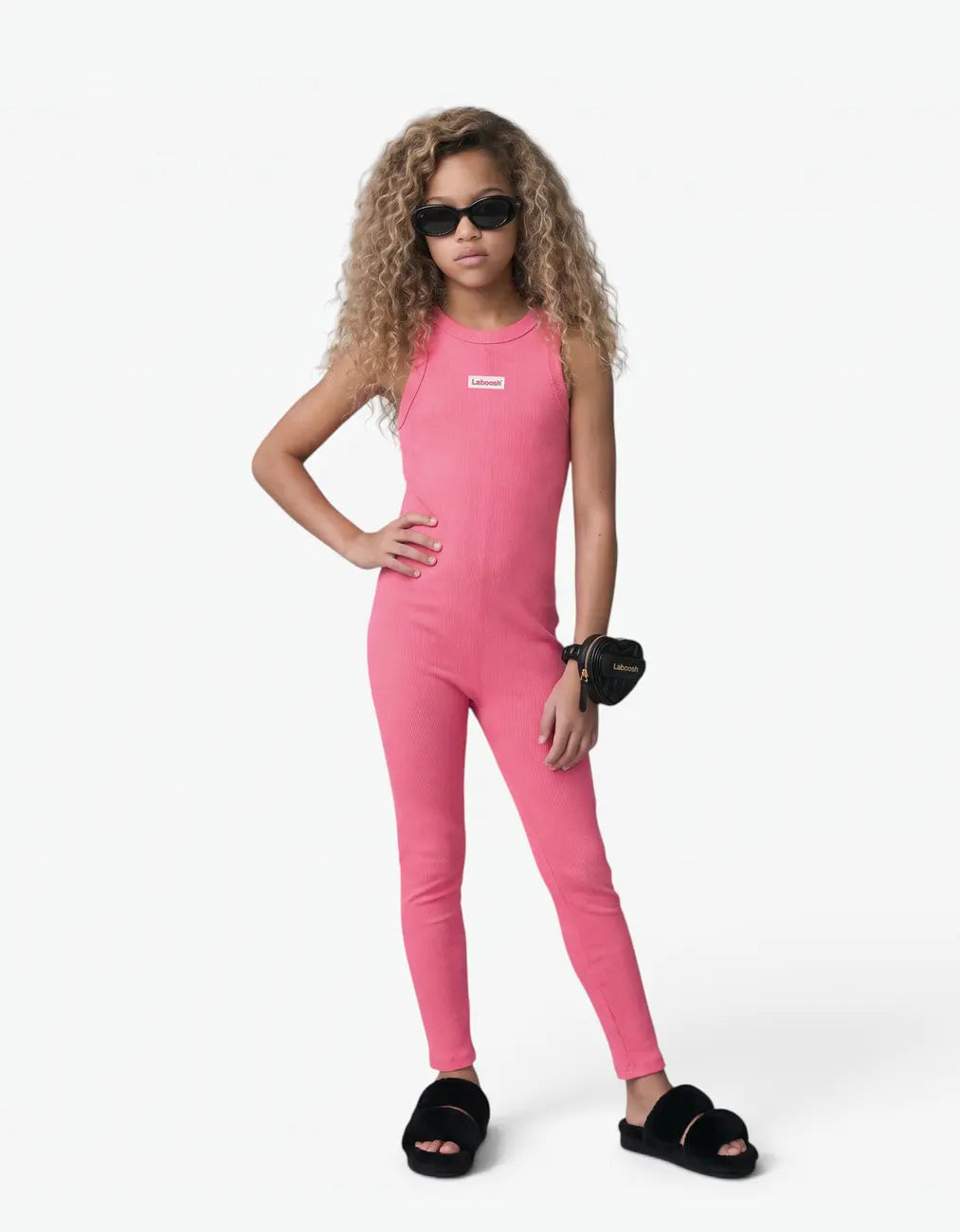 Pink ribbed romper with long pants for girls with Laboosh logo, front view on white background