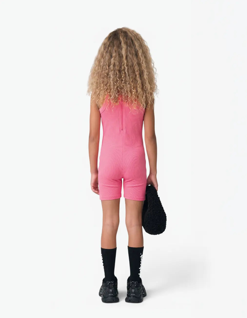 Pink ribbed short romper for girls, back view on white background