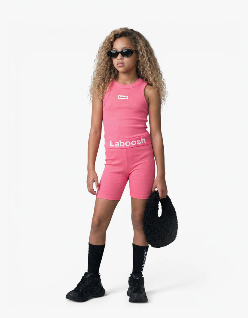 Pink ribbed tank top for girls by Laboosh™, front view, sleeveless ribbed-knit tank styled with matching pink biker shorts and Laboosh™ logo waistband on a white background